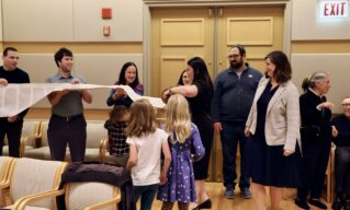 Congregants holding the Torah in Sinai's Sanctuary