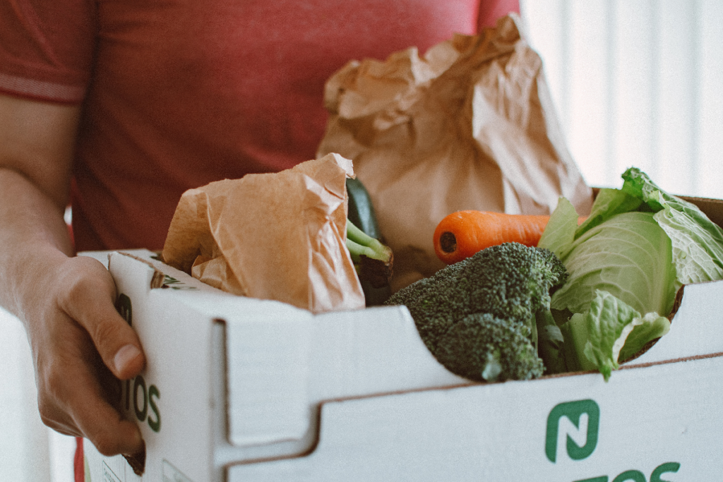 Man holding box of fresh produce