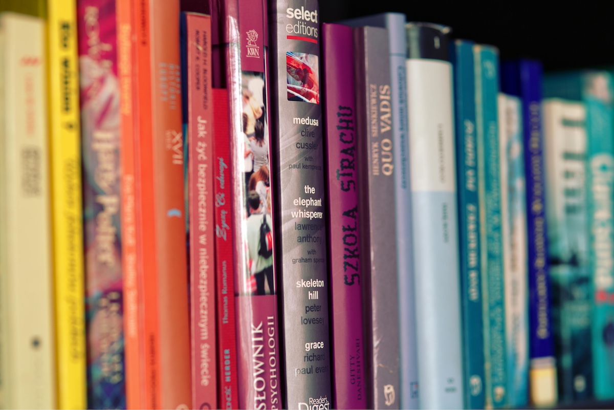 Colorful Books Lined Up on Shelf